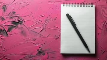 Blank Spiral Notebook and Black Fountain Pen on Pink Surface photo