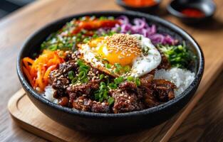 Korean Beef and Rice Bowl With Fried Egg and Sesame Seeds photo