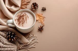Warm Autumn Drink With Knit Blanket and Fall Leaves on Tan Background photo