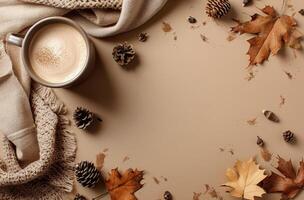 Warm Autumn Drink With Knit Blanket and Fall Leaves on Tan Background photo