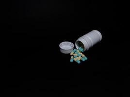 a bottle of medicine in capsules photo