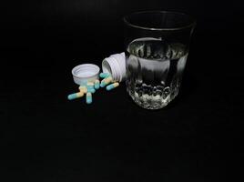 a bottle of medicine in capsules photo