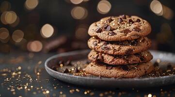 A Stack of Chocolate Chip Cookies on a Plate With Gold Confetti photo