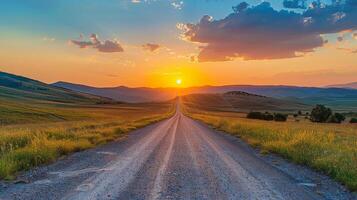 Rural Road Winding Through Green Hills at Sunset photo