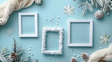 White Picture Frames With Winter Decor on Blue Background photo