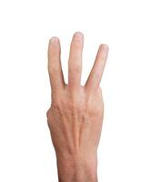 Hand showing three fingers, isolated on white background. Gesture indicating the number three, ideal photo