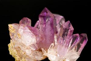 Macro of amethyst mineral stone on black background photo