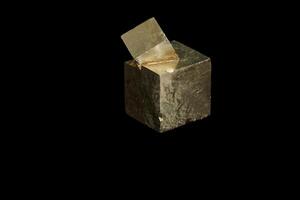 Macro mineral stone Pyrite on a black background photo