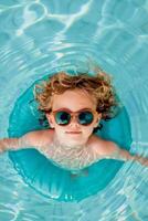 cute toddler in inflatable ring in a pool photo