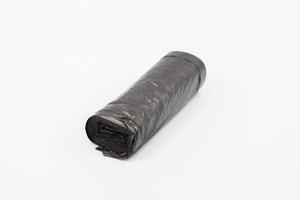 Black plastic garbage bags on white background, Roll of garbage bags on white background photo