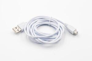 USB cable for smartphone on white background, White usb cable on white background, computer peripherals connector or smartphone recharge supply photo