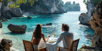 Romantic couple dining by a beach in a tropical paradise with ocean view and greenery photo