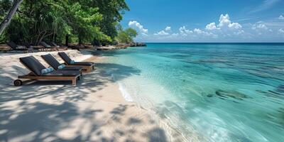 Lounge chairs on a sandy beach by the ocean under a clear sky with fluffy clouds photo