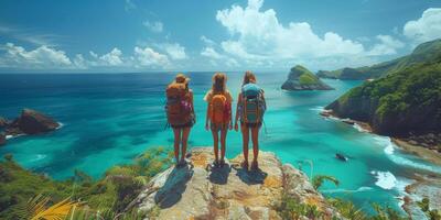 Three people with backpacks on a cliff near the ocean photo