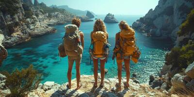 Three individuals with backpacks sitting on a rock near the water photo