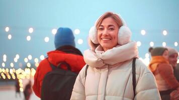 Happy woman in warm clothes looking at camera during Christmas video