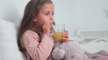 Girl drinking effervescent tablet dissolved in glass with juice video