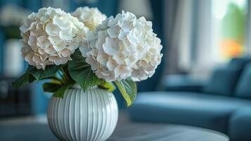 White Hydrangea Bouquet In A Striped Vase On A Table In A Modern Home photo