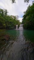 Smooth FPV flight over beautiful waterfall in the lush jungle in Thailand video
