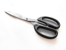 A pair of scissors with a black handle and a white background photo