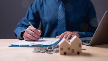 The estate agent's signature on the contract finalized the mortgage agreement, marking a significant investment in the housing property for business purposes. photo