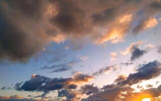Sun Setting Over Clouds in Sky photo