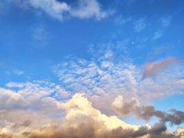 Sun Setting Over Clouds in Sky photo
