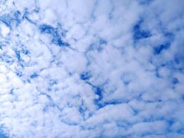 Clear blue sky texture and white fluffy cloud nature background. The sun shines bright in the daytime in summer photo
