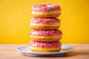 Stack of pink doughnuts on the plate photo