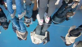 Mirror reflecting people's legs with photo