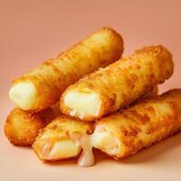Crispy mozzarella cheese sticks, golden brown and cheesy, isolated on a pink background. photo