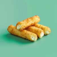 Close up of crispy golden mozzarella cheese sticks on a green background. Delicious and cheesy snack food, perfect for parties or game day. photo