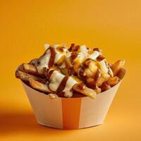 Poutine with cheese curds, gravy, and fries in a paper cup, a popular Canadian dish. Close up shot of delicious food on a yellow background. photo