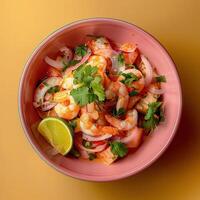 Shrimp ceviche with lime and cilantro, a refreshing and flavorful seafood dish. Close-up view of a ceviche bowl with a yellow background. photo