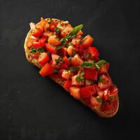 Close up of tomato bruschetta with fresh basil on top, italian food, appetizer photo