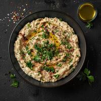 Delicious Baba Ganoush Dip with Herbs, Spices, and Olive Oil. Middle Eastern and Mediterranean Cuisine, Vegetarian Appetizer. photo