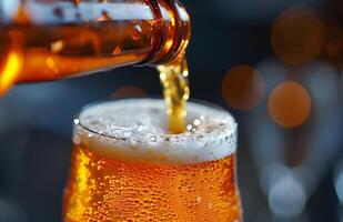 Pouring a glass of golden beer, creating a frothy head, ready to be enjoyed photo
