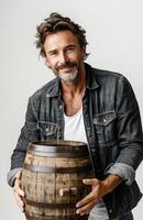 A man holds a wooden barrel against a white background, emphasizing simplicity and contrast photo
