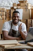 Cheerful Black entrepreneur managing his small business online, packaging orders, and using a tablet for ecommerce photo