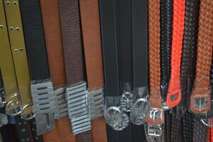 Various color of leather belts neatly arranged photo