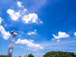 Shiny steel smokestack and cloud in sky photo