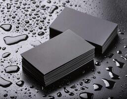 black business cards with water droplets on a black surface photo