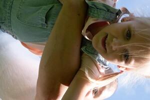 Captured from below, child held high suggests a world of possibilities, security that healthy living and comprehensive health insurance provide, and active lifestyle in nature. photo