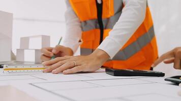 Construction and structure concept of engineer working drawing on blueprint meeting for project working with partner on model building and engineering tools in working site, construction concept video