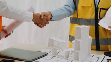 Construction and structure concept of engineer working drawing on blueprint meeting for project working with partner on model building and engineering tools in working site, construction concept video