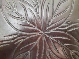 Close up photo of a wood with carved design
