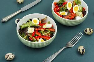 Vegetable salad with quail eggs. photo