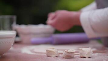 making dumplings, a cook making dumplings in an open kitchen. video