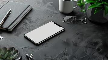Top view of modern workspace with laptop, smartphone and plant on dark table photo