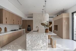 esquina de moderno cocina con blanco y de madera paredes, hormigón piso, blanco encimeras con construido en lavabo y Horno foto